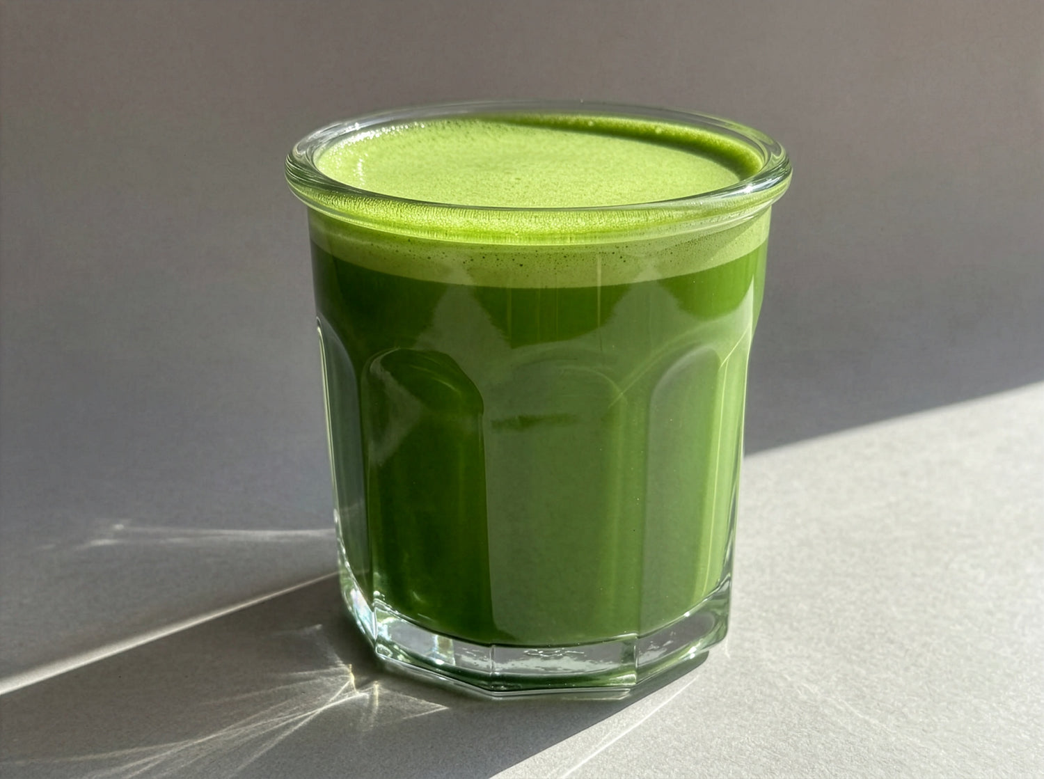Glass of Japanese matcha on a neutral background