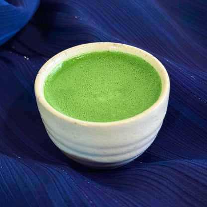 Nishi no Kawa Matcha prepared as usucha in a white cup on a blue background